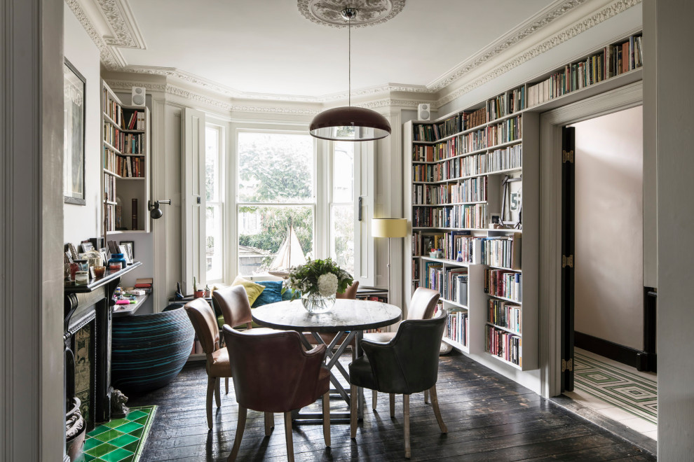 Design ideas for a mid-sized eclectic home office in London with a library, grey walls, dark hardwood floors, a freestanding desk and brown floor.