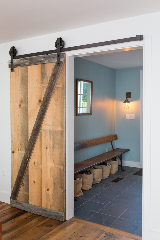 Inspiration for a small country slate floor and black floor mudroom remodel in Boston with blue walls
