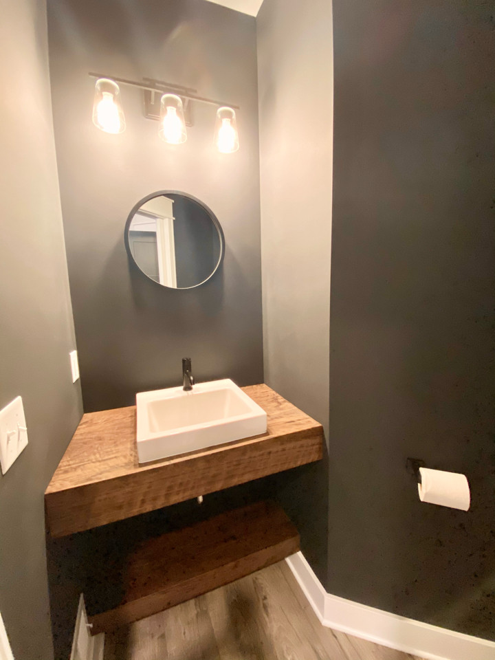 Design ideas for a small traditional bathroom in Grand Rapids with vinyl flooring, a vessel sink, wooden worktops, a shower bench, a single sink and a floating vanity unit.