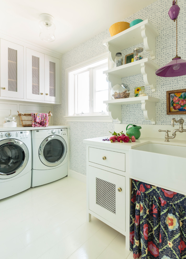 Photo of a mid-sized eclectic l-shaped dedicated laundry room in Los Angeles with a farmhouse sink, shaker cabinets, white cabinets, quartz benchtops, blue walls, painted wood floors, a side-by-side washer and dryer, white floor and beige benchtop.