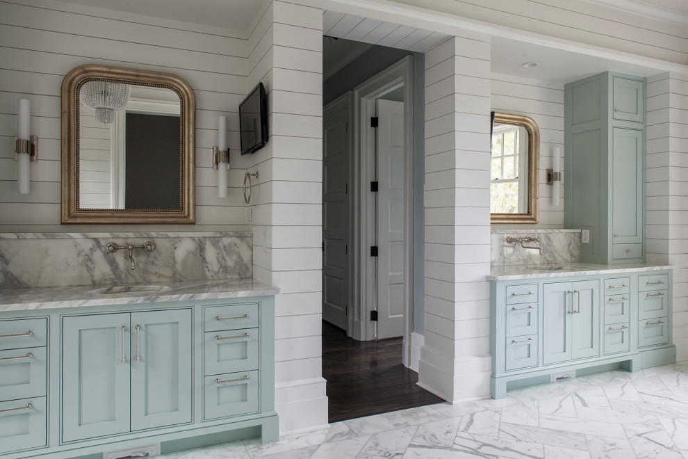 Inspiration for an expansive beach style master bathroom in Atlanta with recessed-panel cabinets, blue cabinets, white walls, marble floors, a drop-in sink, marble benchtops, grey floor and grey benchtops.