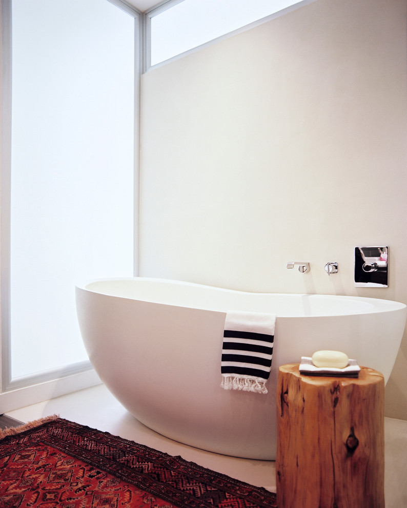 This is an example of a contemporary bathroom in New York with a freestanding tub.
