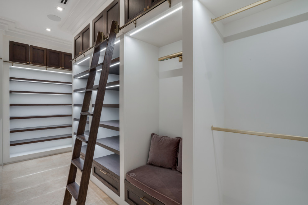 Photo of a contemporary walk-in wardrobe in Miami with recessed-panel cabinets and dark wood cabinets.