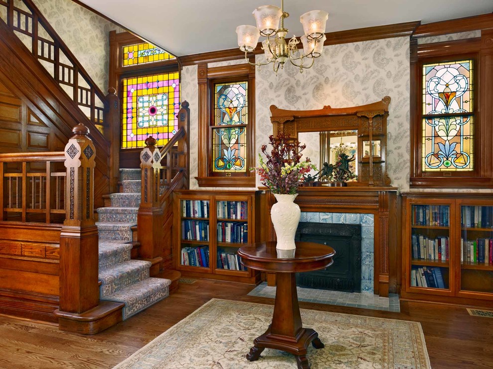 Inspiration for a large traditional foyer in Denver with multi-coloured walls and medium hardwood floors.