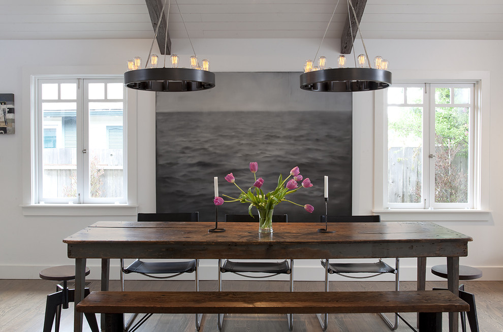This is an example of a contemporary dining room in San Francisco with white walls and dark hardwood floors.