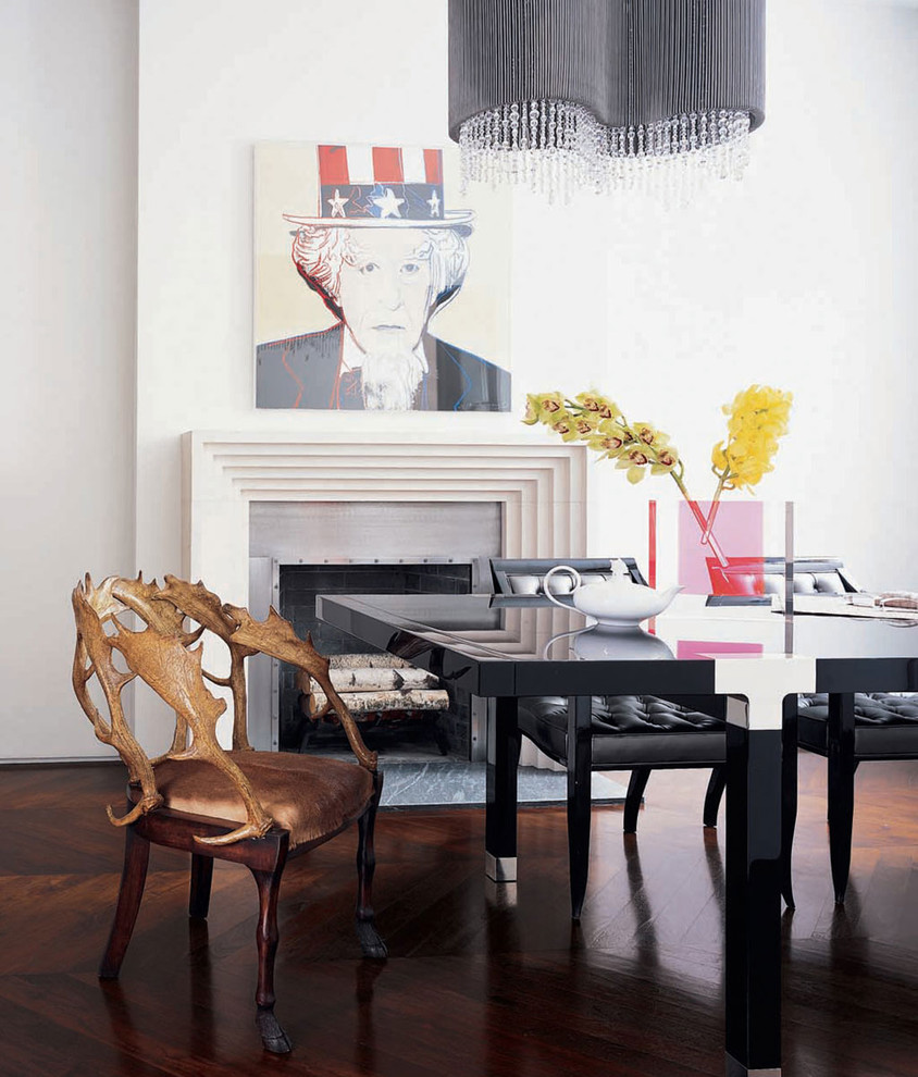 Photo of a contemporary dining room in New York with white walls, dark hardwood floors and a standard fireplace.