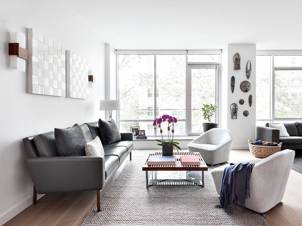 Photo of a transitional formal open concept living room in New York with white walls.
