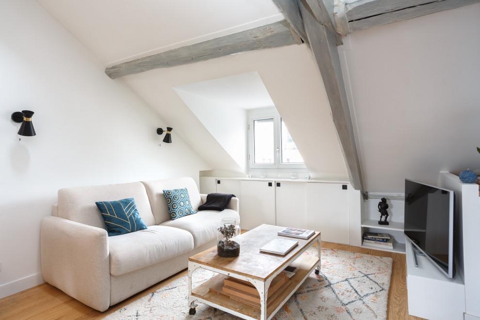 Inspiration for a small contemporary open concept living room in Paris with exposed beam.