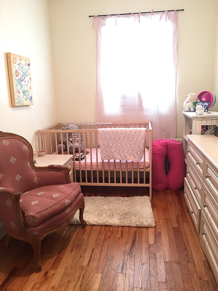 Inspiration for a traditional nursery for girls in New York with beige walls.