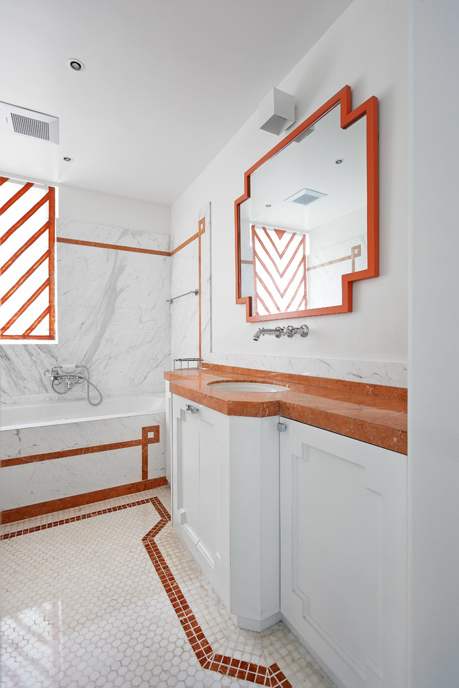 This is an example of a mid-sized traditional bathroom in Rome with raised-panel cabinets, white cabinets, a drop-in tub, multi-coloured tile, marble, white walls, marble floors, a drop-in sink, marble benchtops, multi-coloured floor and orange benchtops.