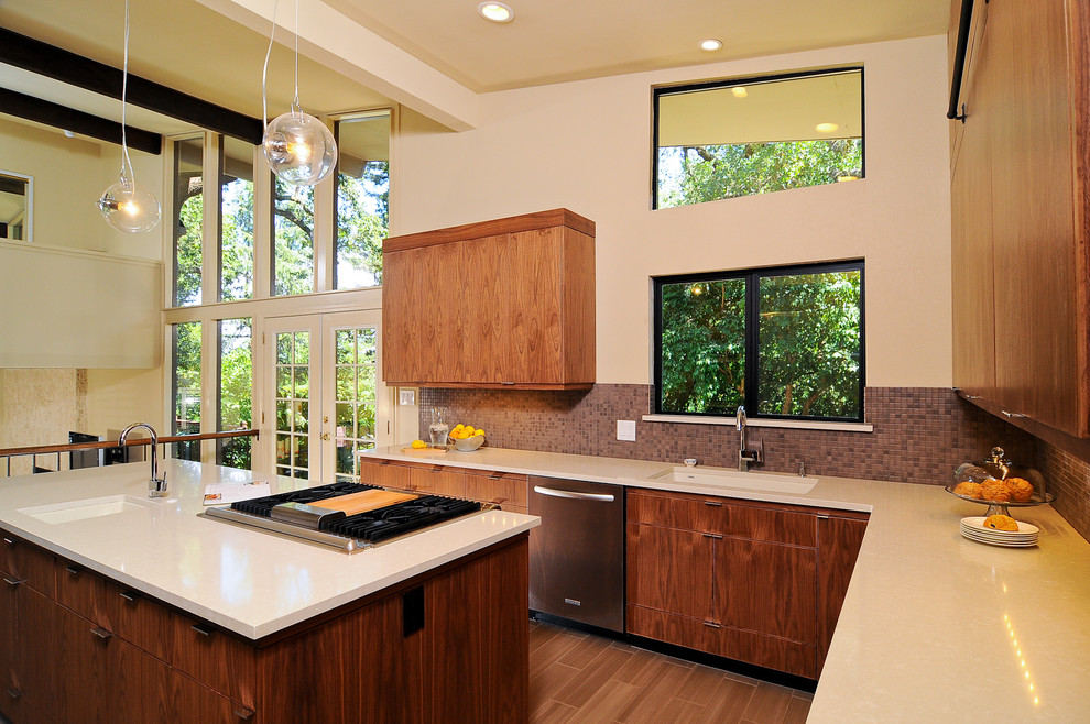 This is an example of a modern kitchen in Sacramento with mosaic tile splashback, flat-panel cabinets and medium wood cabinets.