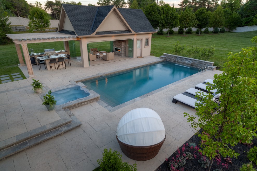 This is an example of a mid-sized contemporary backyard rectangular lap pool in Toronto with a pool house and stamped concrete.