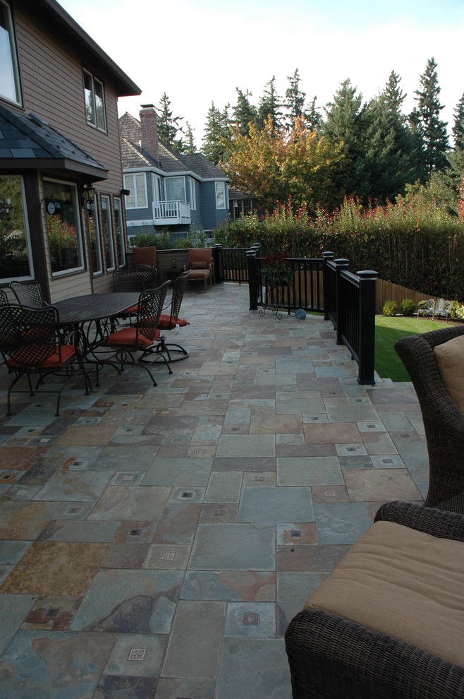 Inspiration for a large eclectic backyard patio in Portland with a fire feature and tile.