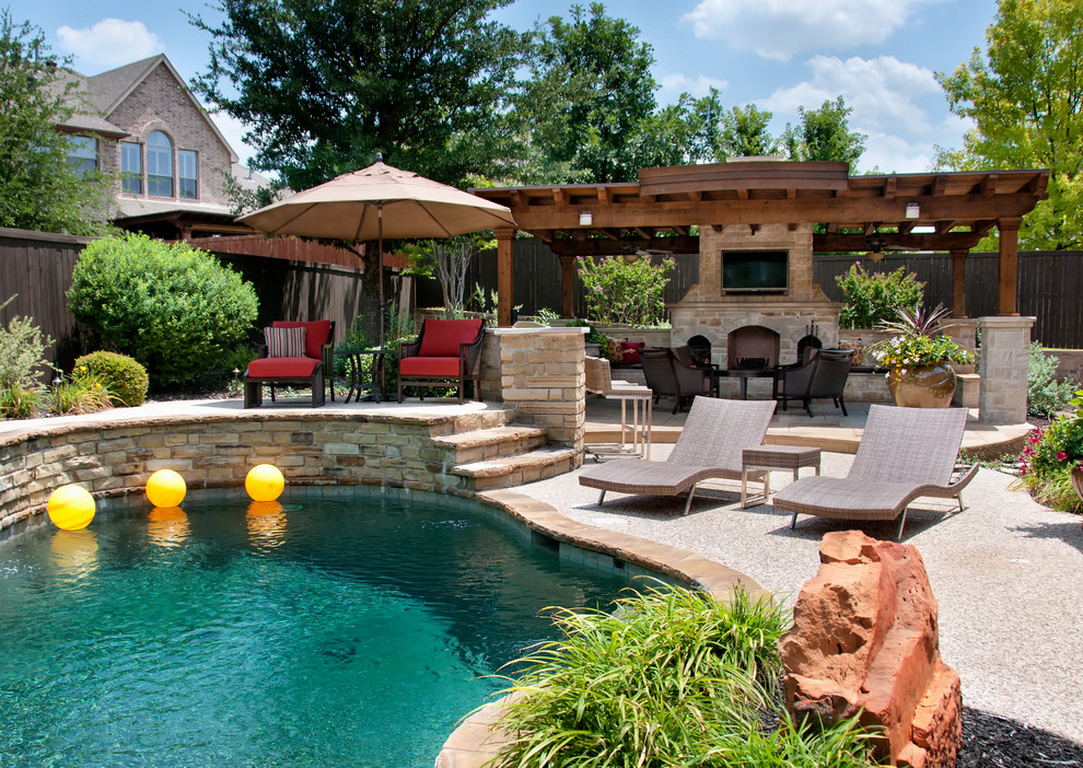 Inspiration for a large traditional backyard custom-shaped pool in Dallas with concrete slab.