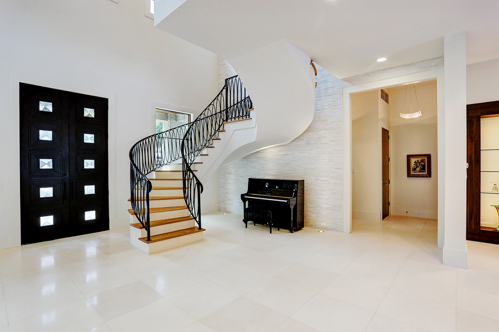 Mid-sized contemporary wood curved staircase in Houston with painted wood risers and metal railing.