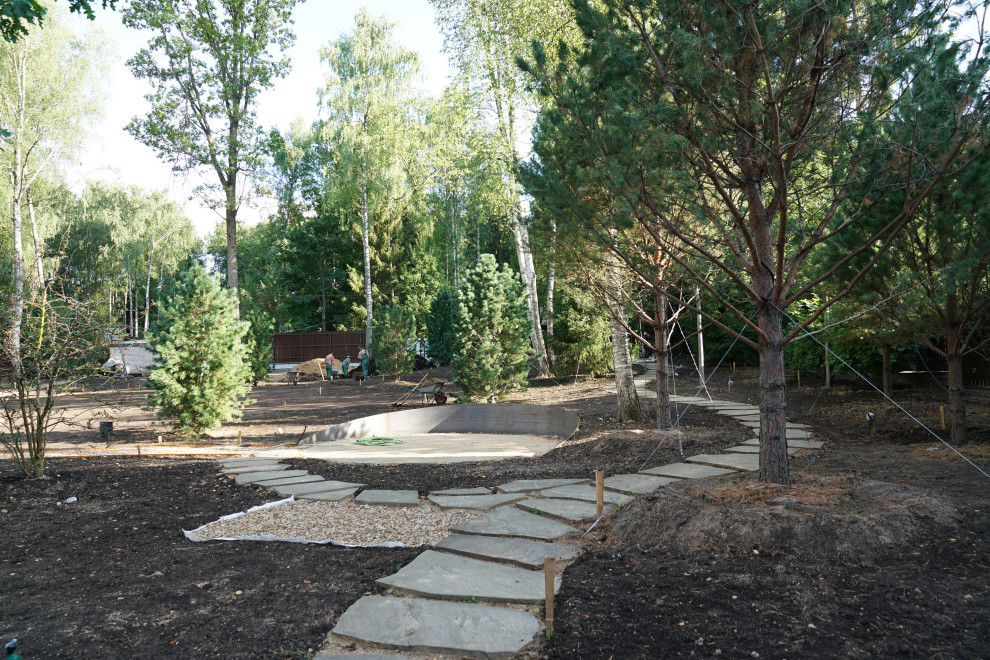 Пример оригинального дизайна: большой летний участок и сад на заднем дворе в стиле кантри с дорожками, полуденной тенью, покрытием из каменной брусчатки и с металлическим забором