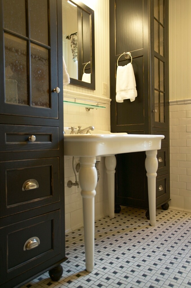 Country bathroom in Other with black cabinets, white tile, subway tile, a trough sink and recessed-panel cabinets.