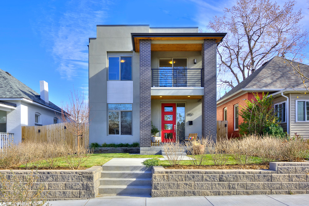 Photo of a contemporary two-storey grey house exterior in Denver with mixed siding and a flat roof.