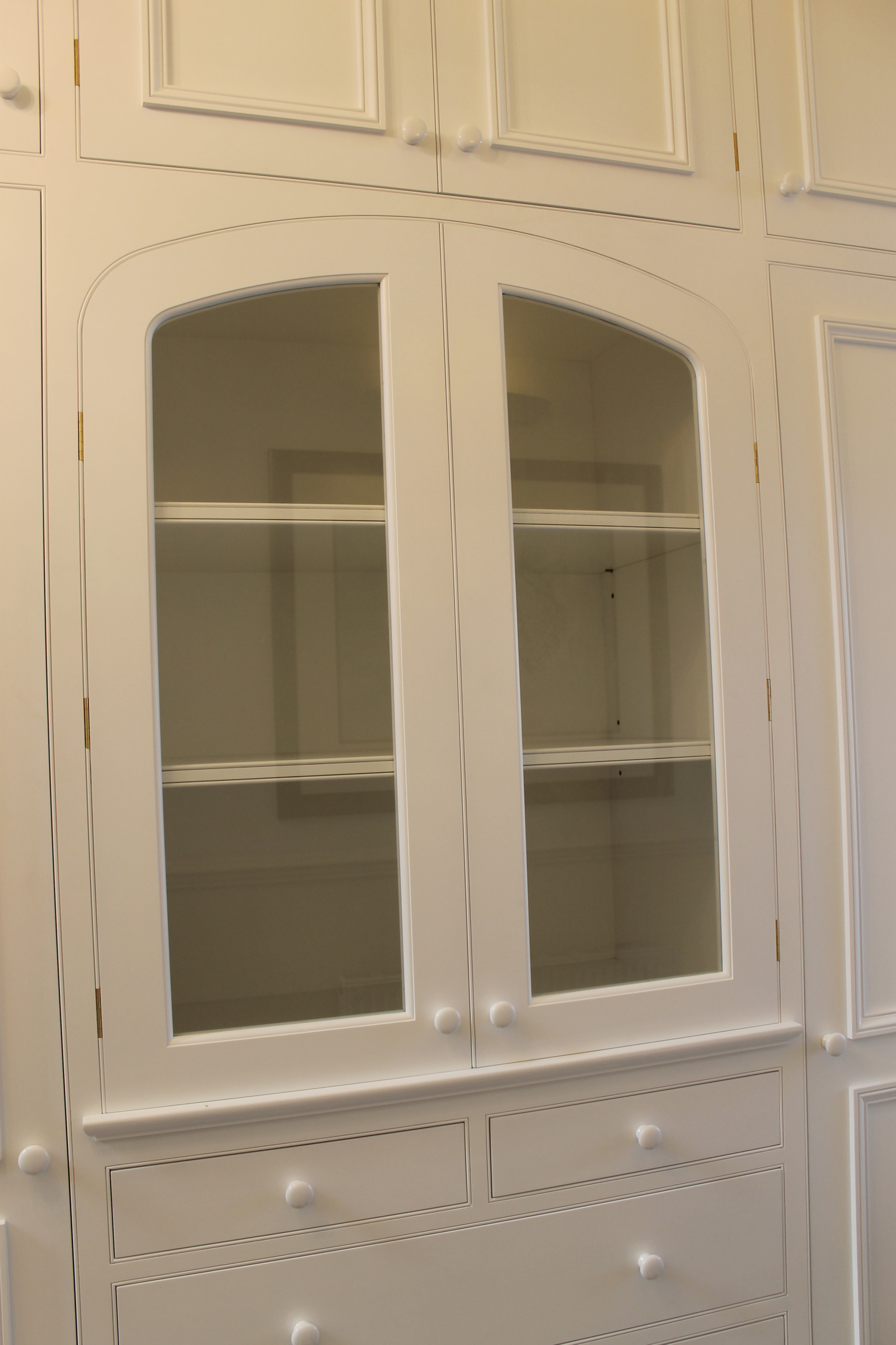 Hallway cabinet with three center arched glazed doors