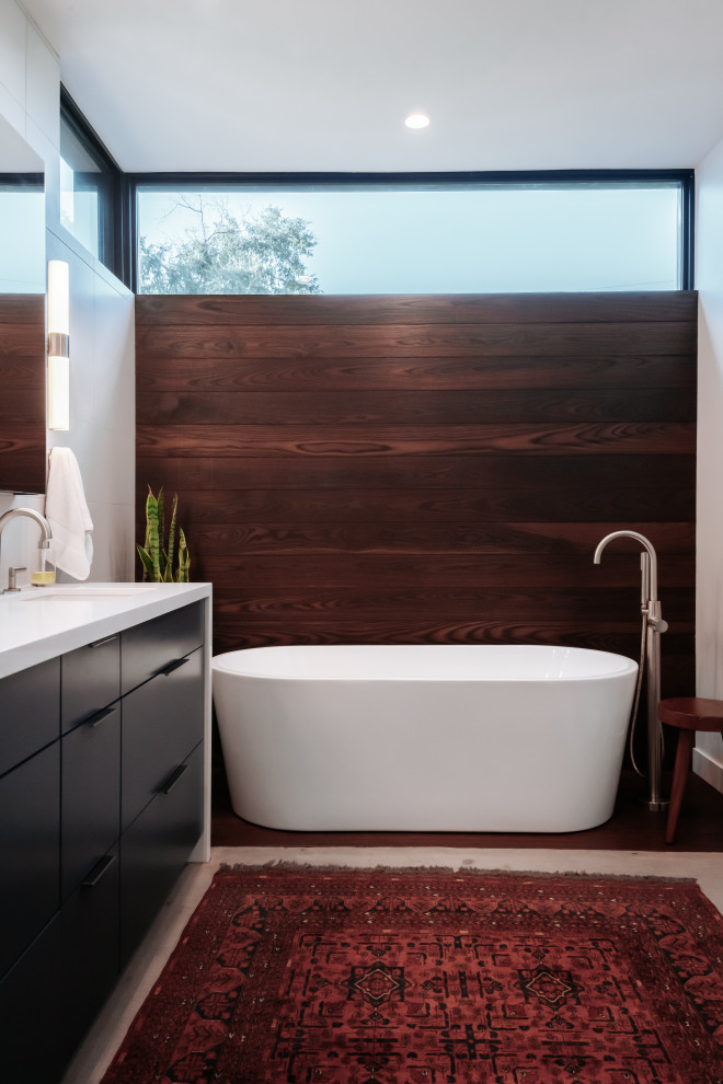 На фото: главная ванная комната среднего размера в стиле модернизм с отдельно стоящей ванной, бетонным полом, столешницей из кварцита, белой столешницей, тумбой под две раковины и напольной тумбой