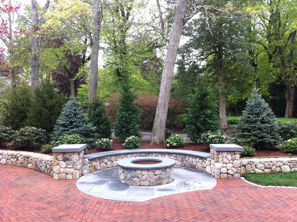 Inspiration for a mid-sized traditional backyard patio in Boston with a fire feature, brick pavers and no cover.