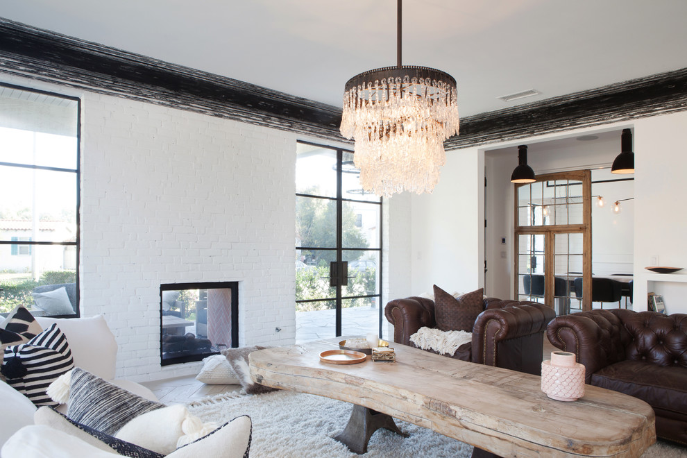 Inspiration for a cottage formal and enclosed living room remodel in Los Angeles with white walls, a two-sided fireplace and a brick fireplace