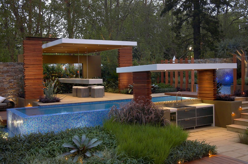 Photo of a contemporary pool in Melbourne with a pool house.