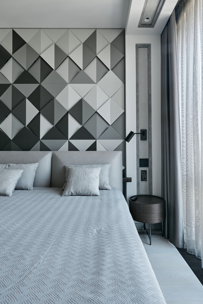 Aménagement d'une chambre parentale contemporaine avec un mur gris.