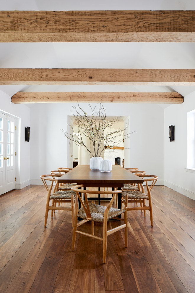 Photo of a large country open plan dining in Other with white walls, medium hardwood floors and brown floor.