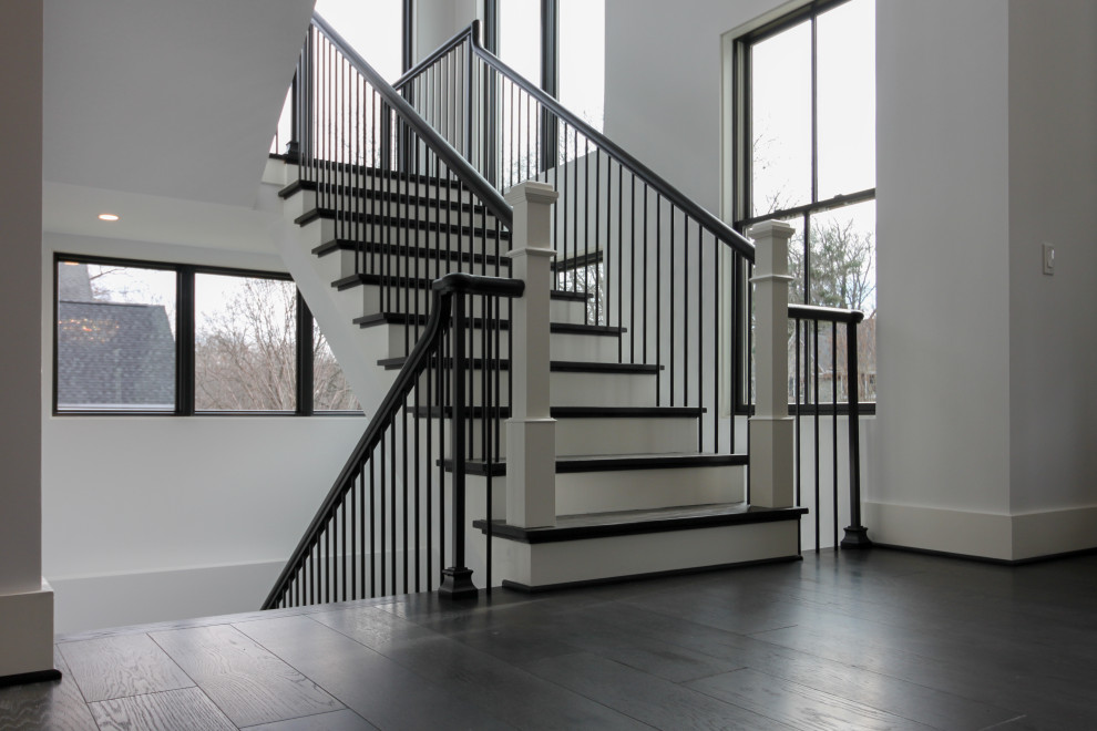 Inspiration for a large traditional wood floating mixed railing staircase in DC Metro with wood risers and panelled walls.