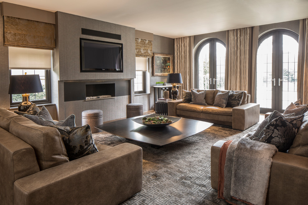 Design ideas for a transitional family room in London with grey walls, a ribbon fireplace and a wall-mounted tv.