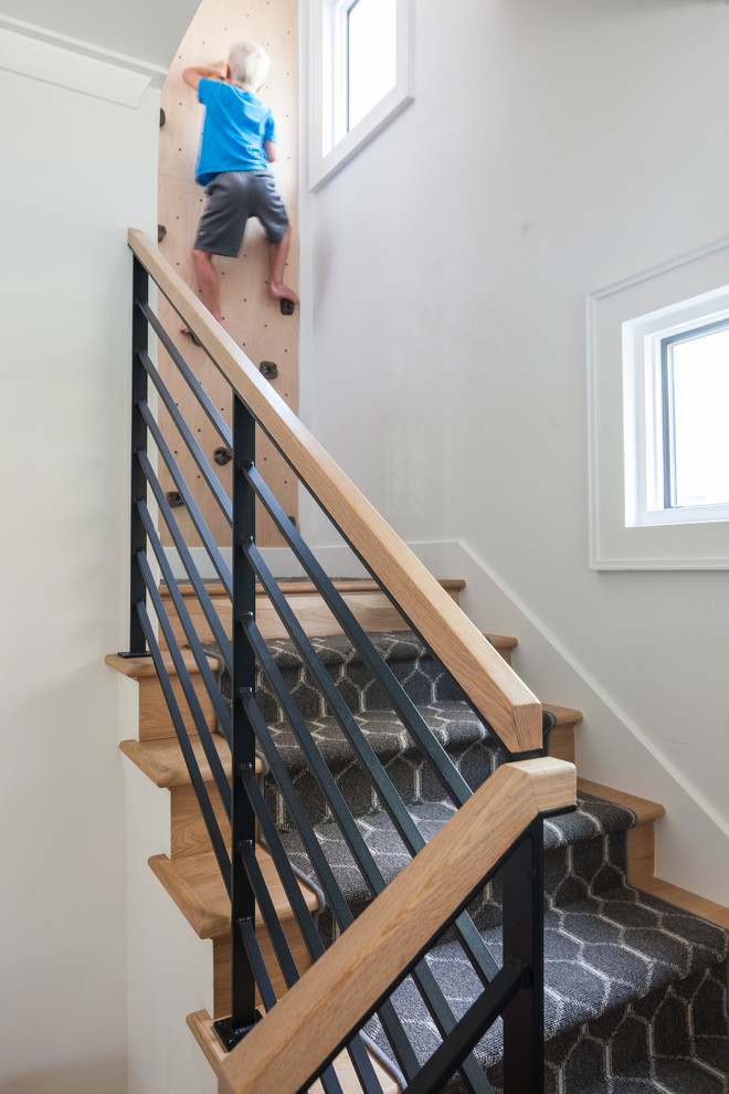 Photo of a mid-sized transitional wood l-shaped staircase in Seattle with wood risers and mixed railing.