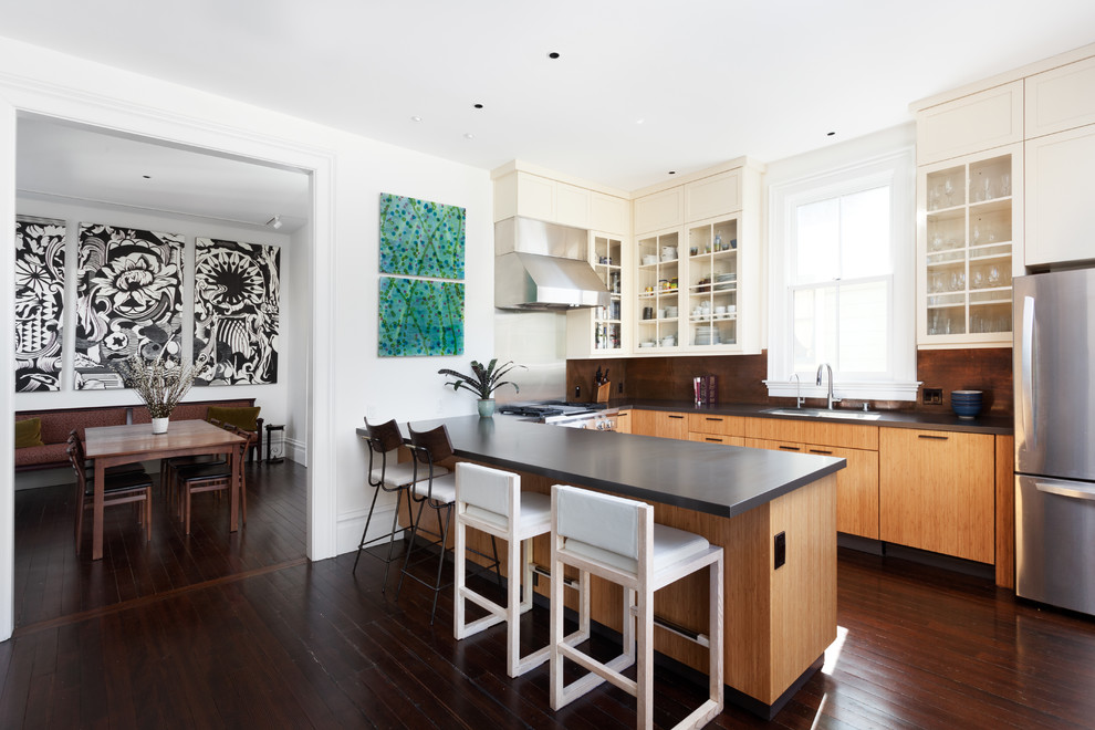 Inspiration for a mid-sized contemporary u-shaped separate kitchen in San Francisco with an undermount sink, flat-panel cabinets, brown cabinets, quartzite benchtops, stainless steel appliances, dark hardwood floors, a peninsula, brown floor, black benchtop and orange splashback.