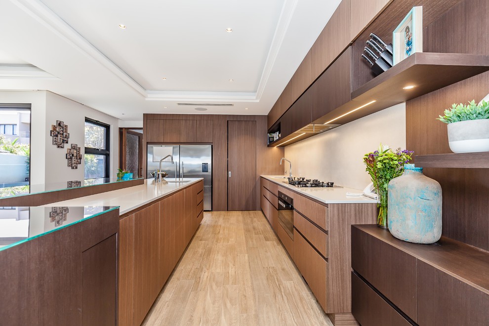 Design ideas for a contemporary l-shaped kitchen in Perth with an undermount sink, flat-panel cabinets, dark wood cabinets, white splashback, stainless steel appliances and with island.