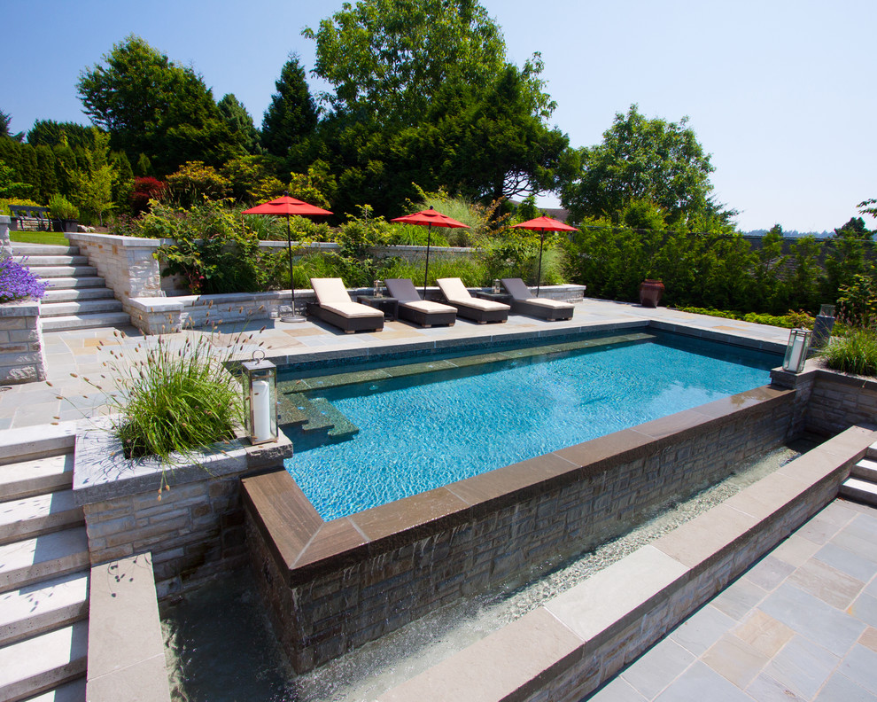 Traditional backyard rectangular infinity pool in Vancouver.