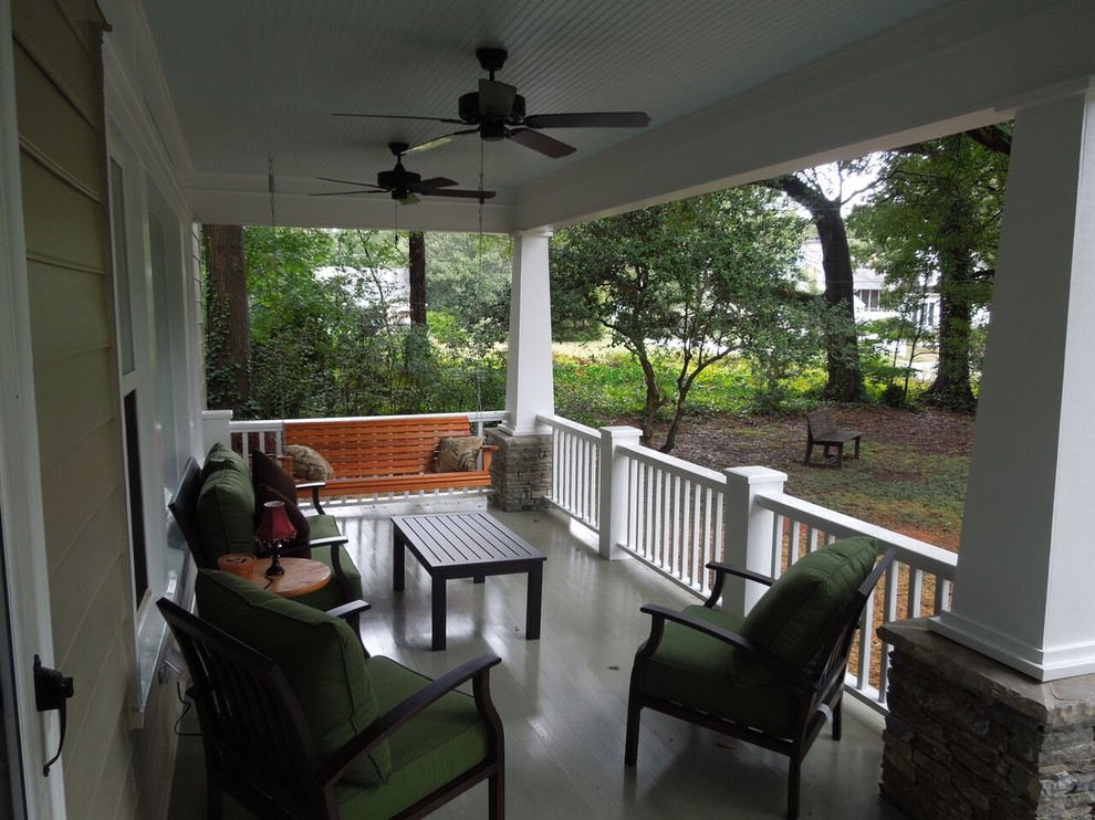 This is an example of a mid-sized arts and crafts front yard verandah in Atlanta with a roof extension.