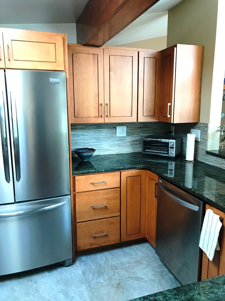 Photo of a large modern kitchen in Other with an undermount sink, raised-panel cabinets, light wood cabinets, granite benchtops, porcelain floors and green benchtop.
