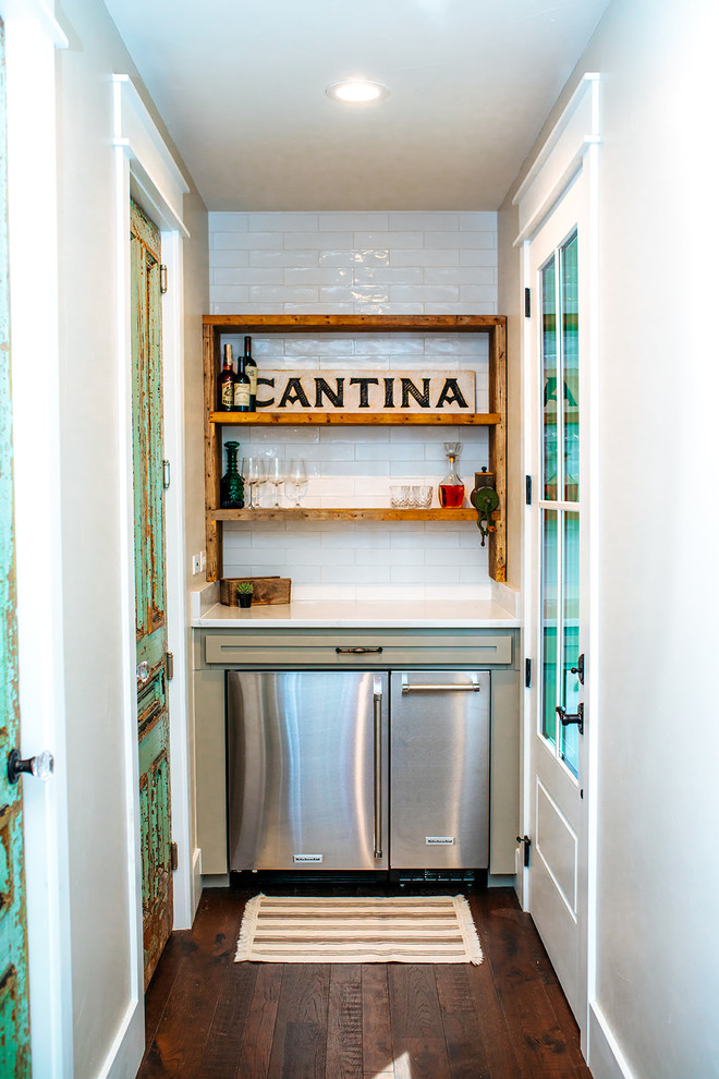 This is an example of a small country single-wall bar cart in Austin with no sink, shaker cabinets, green cabinets, granite benchtops, white splashback, subway tile splashback, bamboo floors, brown floor and white benchtop.