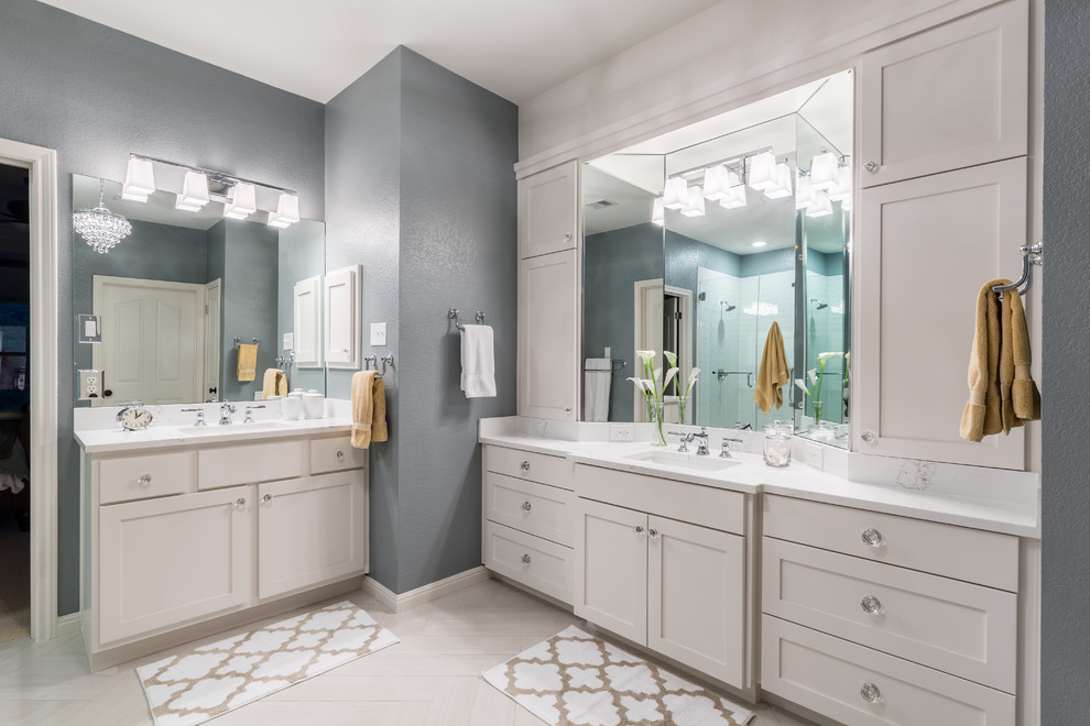Example of a mid-sized transitional master porcelain tile corner shower design in Austin with shaker cabinets, gray walls and an undermount sink