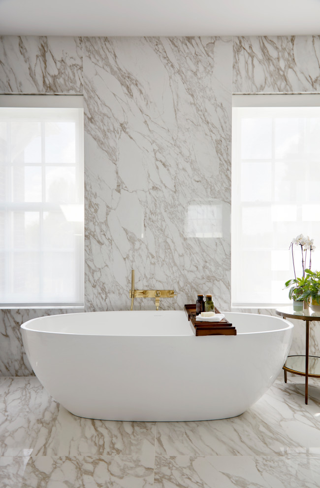Idéer för att renovera ett mycket stort funkis vit vitt en-suite badrum, med släta luckor, bruna skåp, ett fristående badkar, en hörndusch, en vägghängd toalettstol, grå kakel, keramikplattor, flerfärgade väggar, klinkergolv i keramik, ett väggmonterat handfat, marmorbänkskiva, flerfärgat golv och dusch med gångjärnsdörr