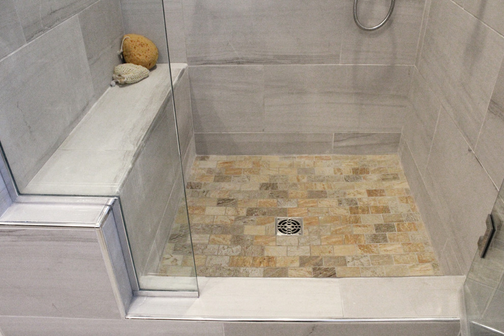 Inspiration for a mid-sized transitional master gray tile and porcelain tile porcelain tile corner shower remodel in Boston with shaker cabinets, dark wood cabinets, a two-piece toilet, gray walls, an undermount sink and quartz countertops