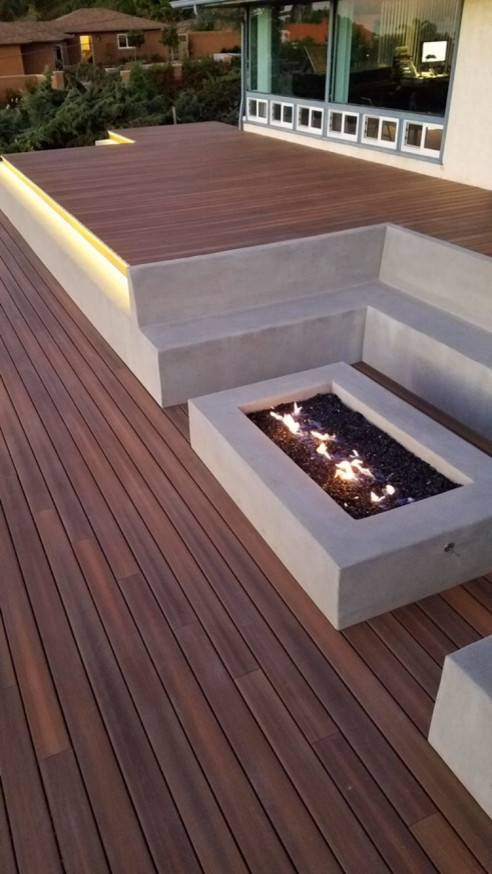Photo of a mid-sized modern backyard deck in Orange County with a fire feature and no cover.