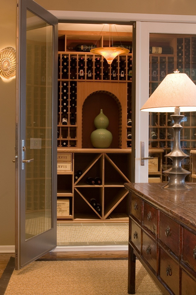 This is an example of a mid-sized traditional wine cellar in Milwaukee with porcelain floors and storage racks.