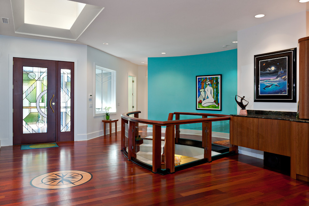 This is an example of a contemporary foyer in Other with blue walls, a single front door and red floor.