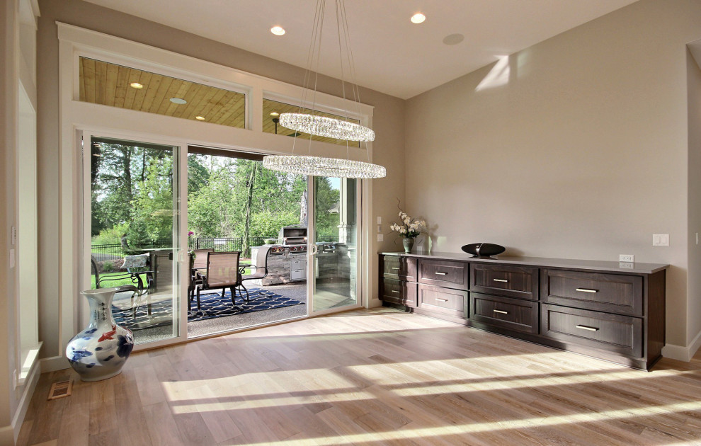 Photo of a large modern open plan dining room in Portland with beige walls, light hardwood flooring and brown floors.
