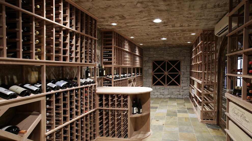 Design ideas for a mediterranean wine cellar in Detroit with slate floors.