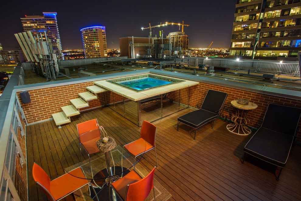 Photo of a small modern rooftop rectangular aboveground pool in Dallas with decking.