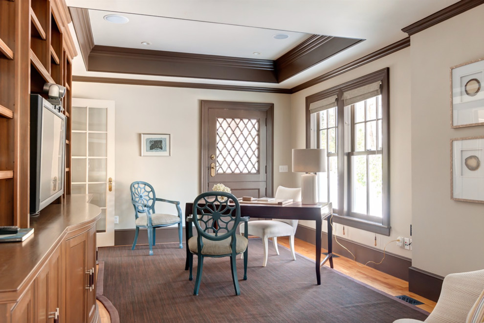 This is an example of a large transitional study room in Boston with beige walls, medium hardwood floors and a freestanding desk.