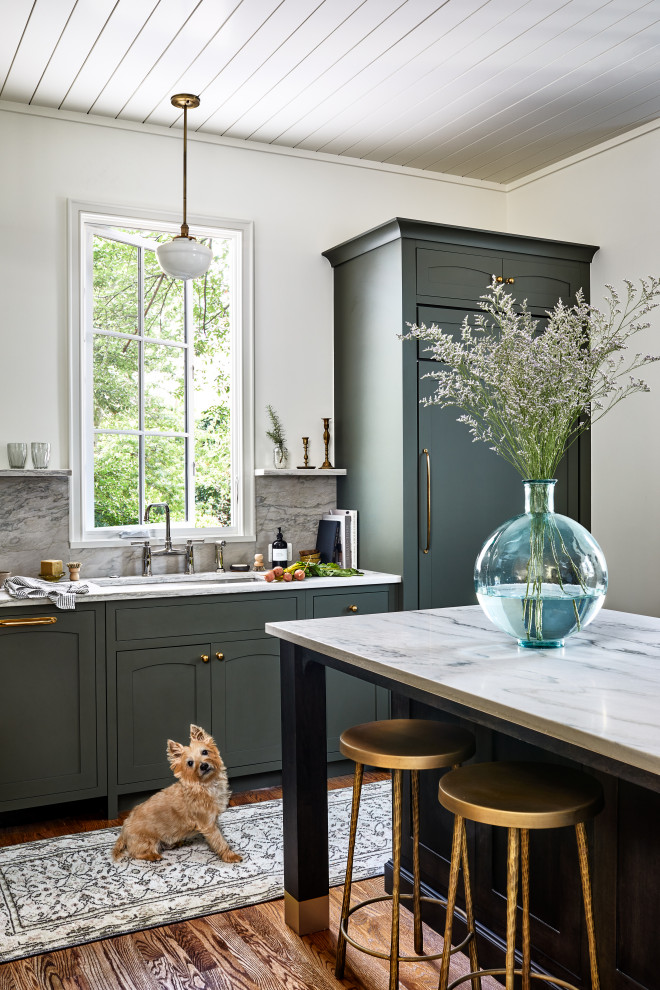 Large classic enclosed kitchen in DC Metro with a submerged sink, beaded cabinets, green cabinets, quartz worktops, grey splashback, stone slab splashback, integrated appliances, medium hardwood flooring, an island, brown floors, grey worktops and a timber clad ceiling.