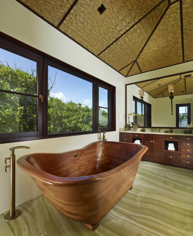 Mid-sized asian master bathroom in Other with recessed-panel cabinets, dark wood cabinets, a freestanding tub, beige walls, marble floors, an undermount sink, marble benchtops, green floor and white benchtops.